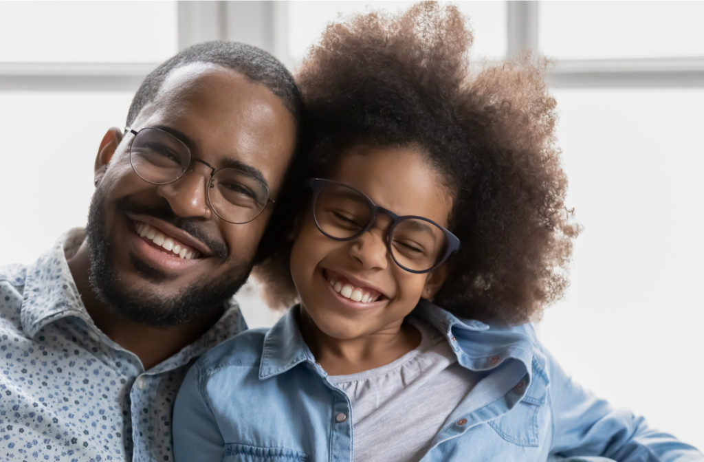 Father and child posing for camera with their new glasses that have anti reflective coating